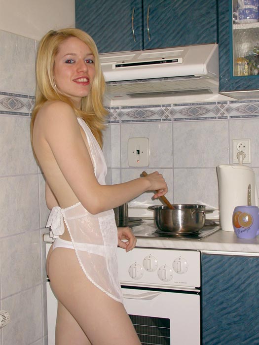 Blonde Teen Girl Showing Her Cooking Skills In The Kitchen  
