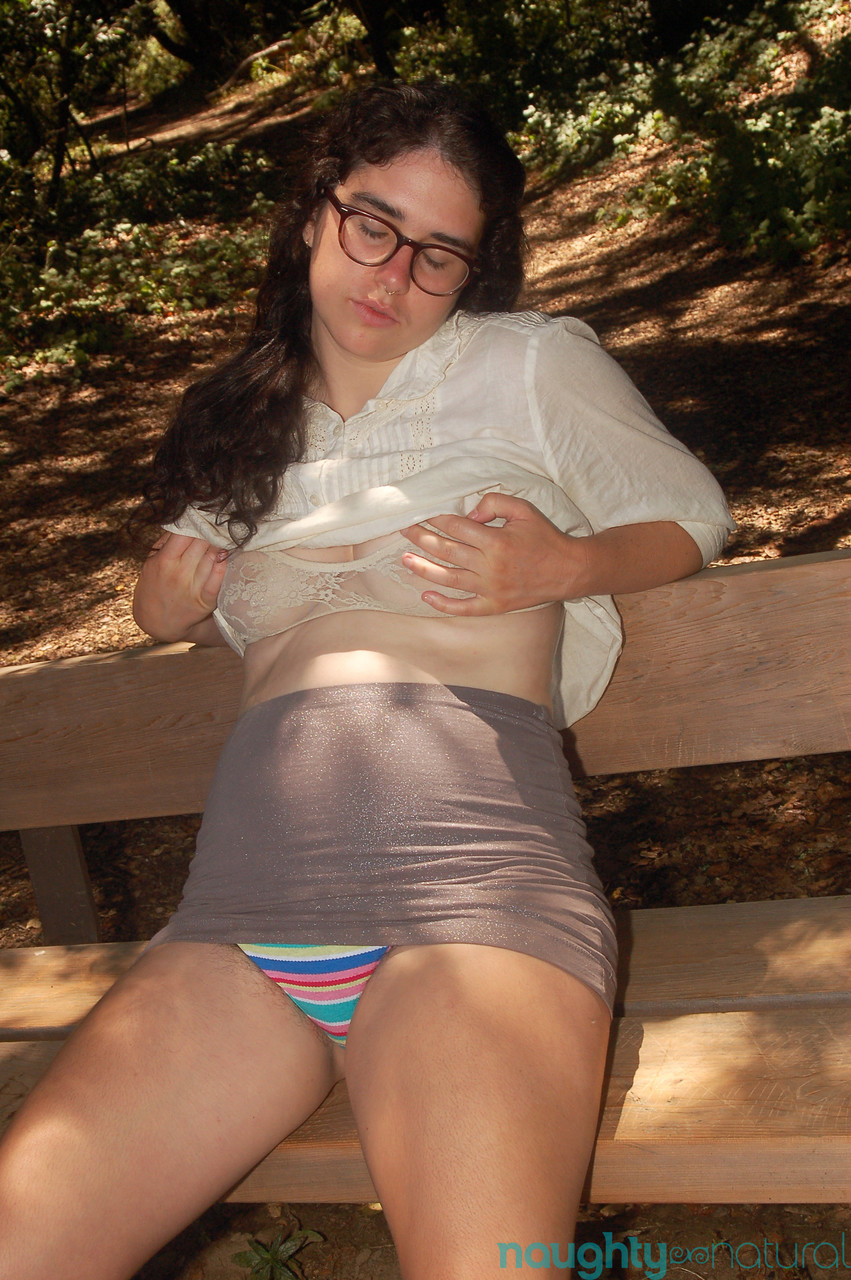 Geeky amateur teen Lucy Haze strips at the park and shows her hairy body