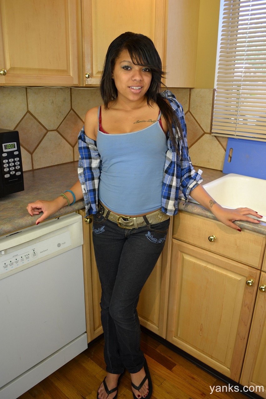 Amateur ebony teen Kimberly Marie stimulates her black clitoris in the kitchen