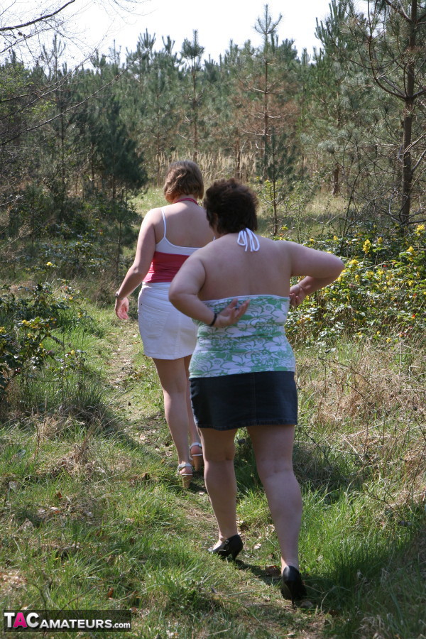 Older lady Kinky Carol and her girlfriend expose their large tits near trees