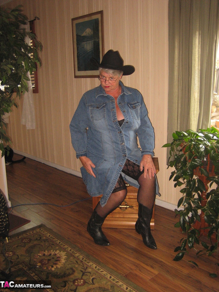 Fat oma Girdle Goddess strips naked in a cowgirl hat and boots