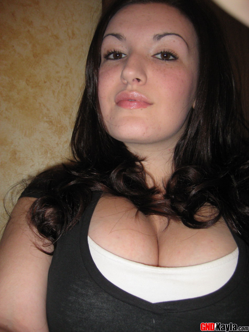 Curvy brunette amateur goes topless during self shot action in a bathroom