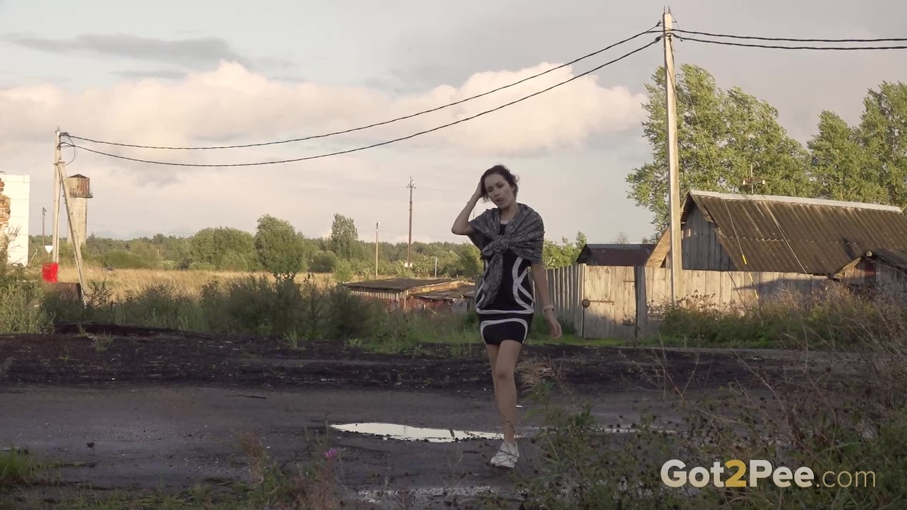 Leggy girl Kristina takes a piss behind a dilapidated building