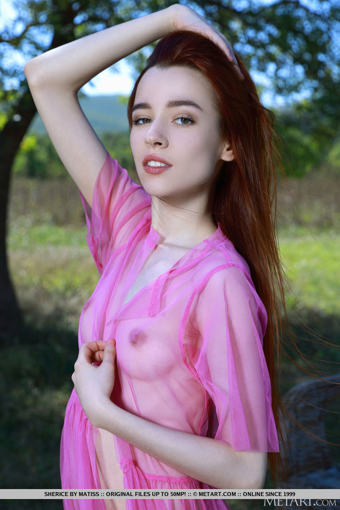 Thin redheaded teen Sherice strikes great nude poses under a shade tree