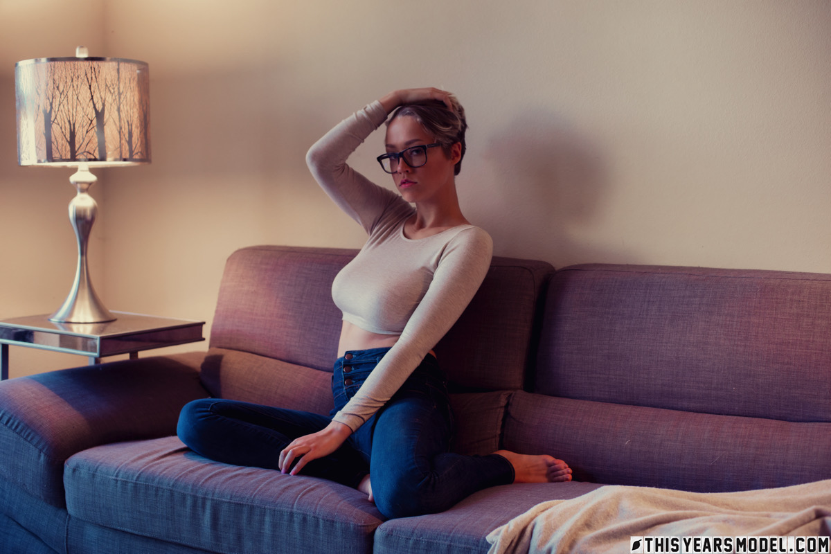 Sexy amateur Sabrina Bunny unleashes her big boobs on a sofa in glasses