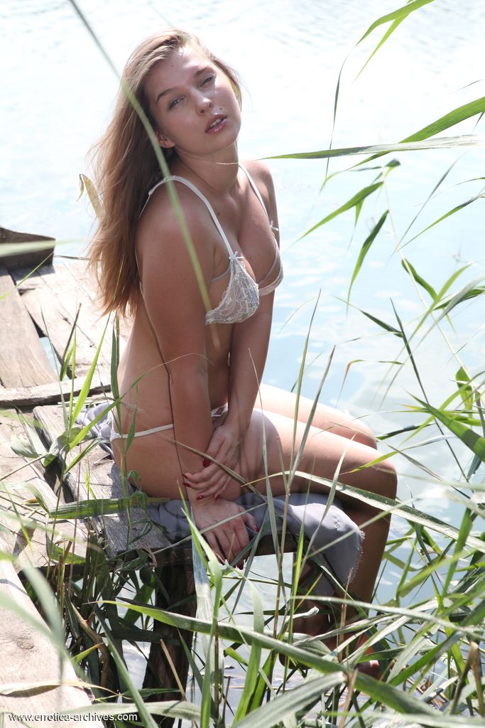 Young beauty Beverly A takes off her bikini to go nude on a dock