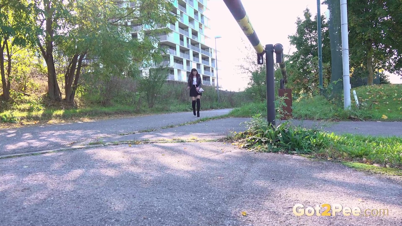 Solo girl Katy Rose squats for a piss on a street in over the knee boots