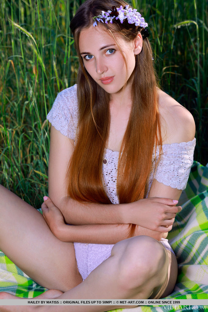 Young girl Hailey gets naked on a blanket in front of tall grasses  