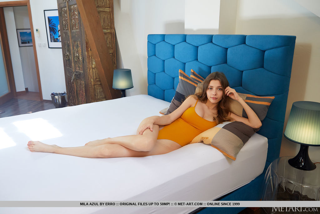 Sweet teen Mila Azul removes a bodysuit to model totally naked on her bed