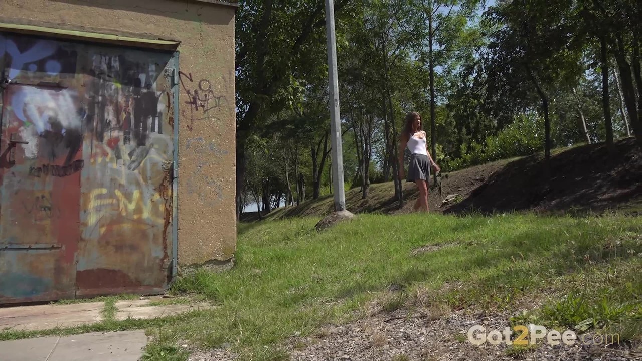 Skinny beauty Sarah Key takes a piss in front of an outbuilding