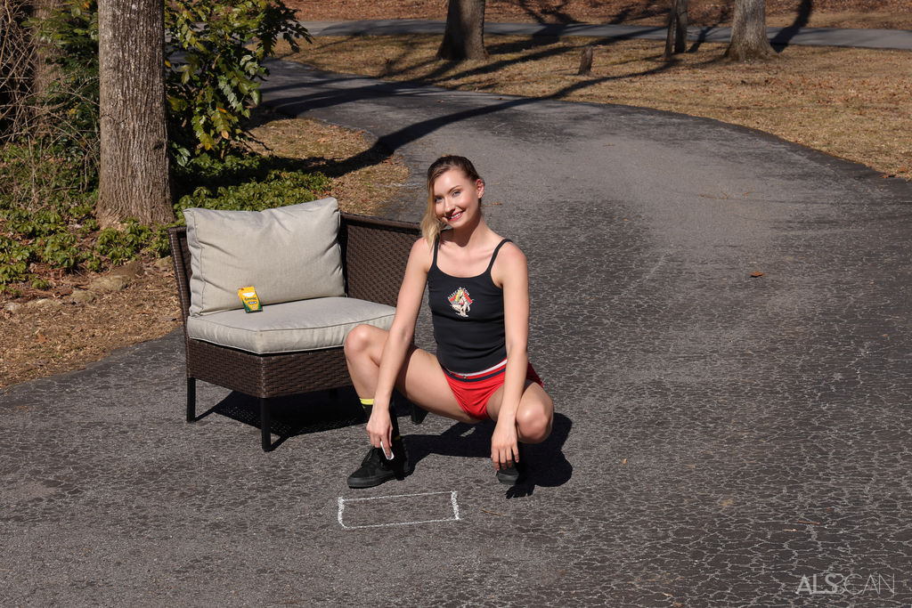 Athletic teen Emma Sirus masturbates on a driveway before taking a piss