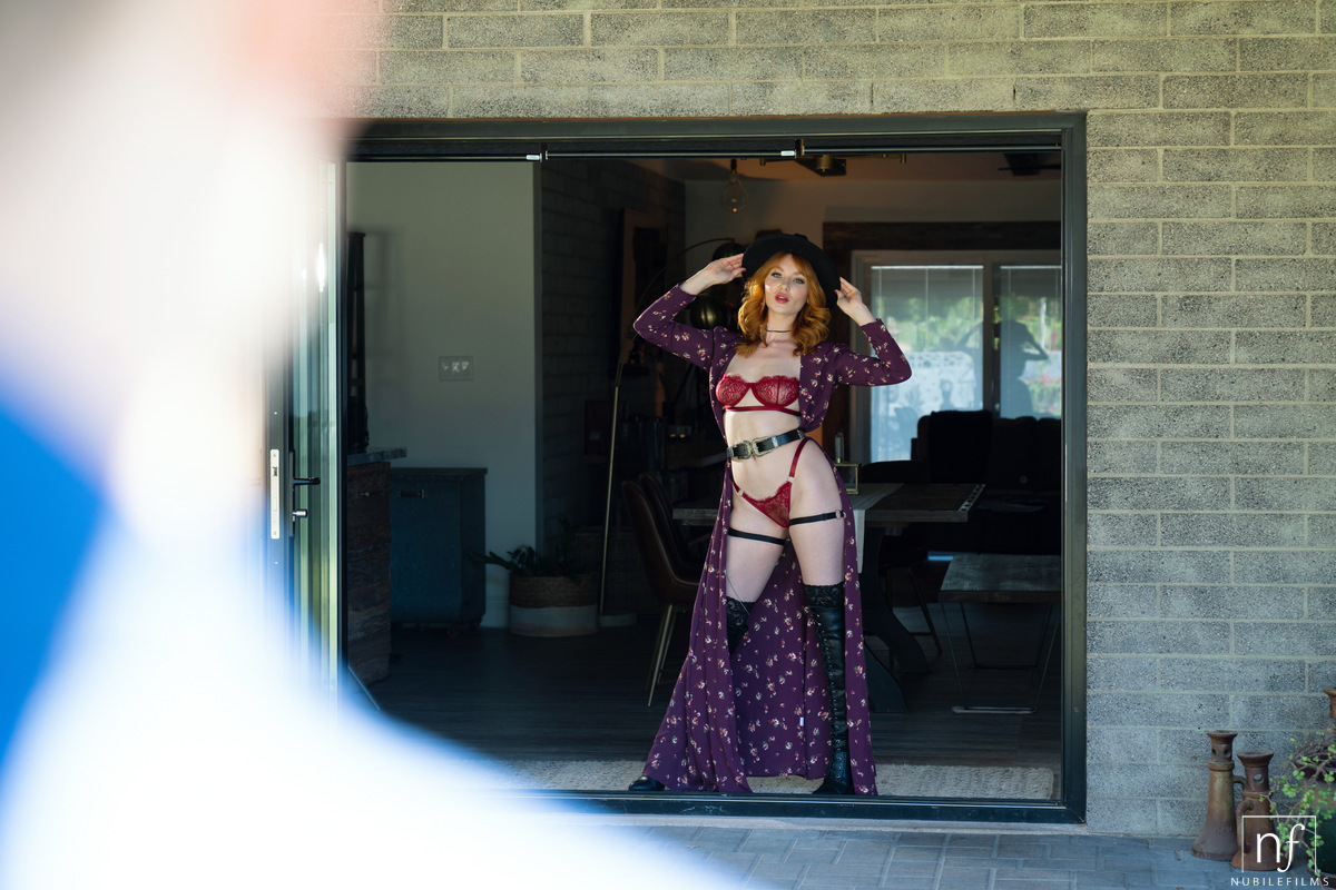 Sexy redhead Lacy Lennon seduces her man in a cape and lingerie plus OTK boots