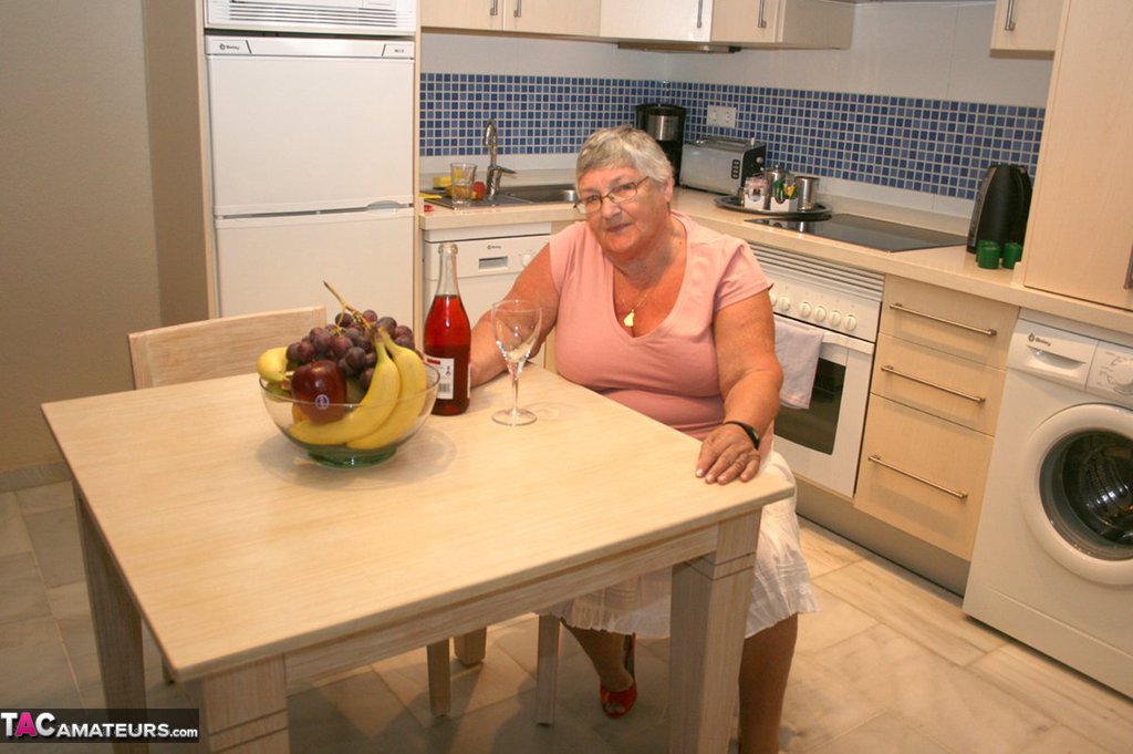 Time For Grandma To Relax In The Kitchen With A Bottle Of Wine And A Bowl Of Fruit. Wine